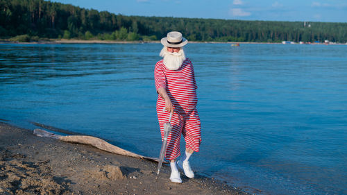 Rear view of woman standing in water