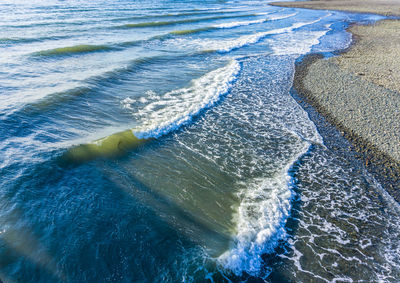 Waves roll toward shore in des moines, washington.