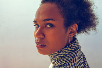 Close-up portrait of young woman looking away