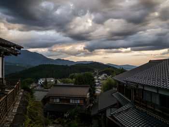 High angle view of houses in town against sky