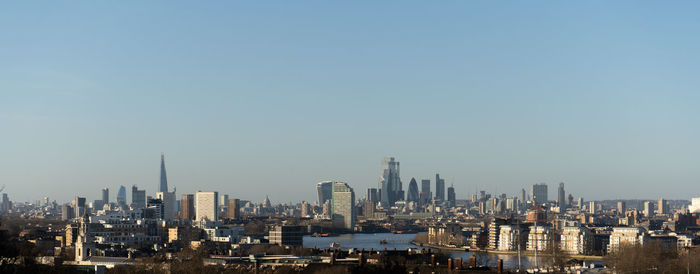 Modern buildings in city against clear sky