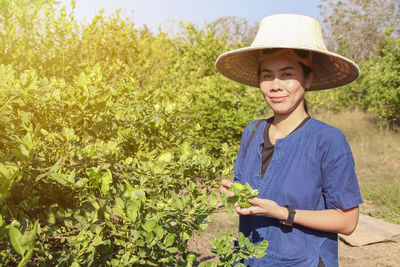 Portrait of smiling girl standing against plants