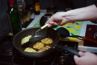 Midsection of person preparing food in kitchen