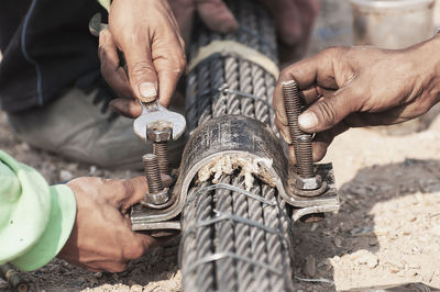 High angle view of people with metal working at construction site