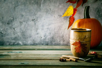 Close-up of orange on table against wall