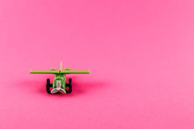 Close-up of toys against pink background