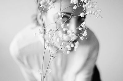 Woman behind flowers