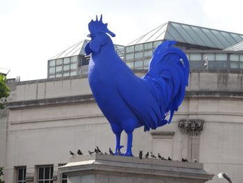 Low angle view of statue against building