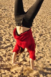 Low section of person on sand at beach