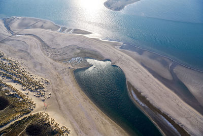 High angle view of land and sea against sky