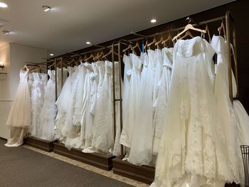 Wedding dresses hanging in shop for sale