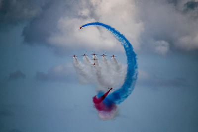 Low angle view of airshow against sky