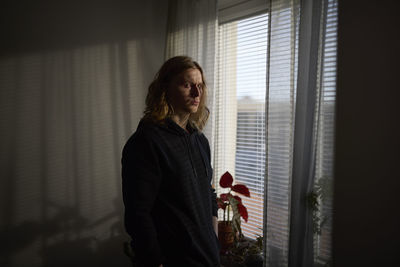 View of woman standing in front of window