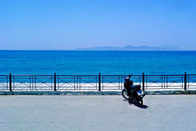 Man riding on sea against clear sky