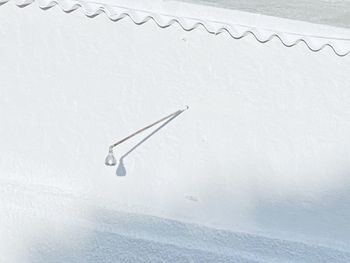 High angle view of snow on paper against wall