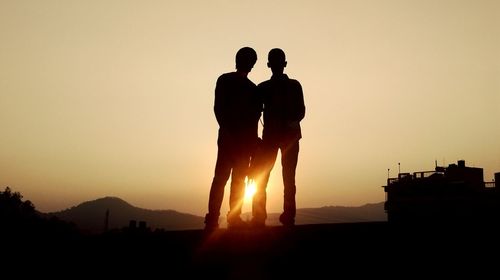 Silhouette people at sunset