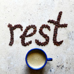 High angle view of coffee bean word art on stone table 