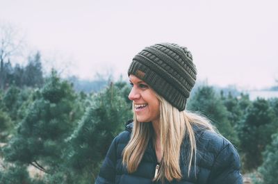 Portrait of smiling young woman in park during winter