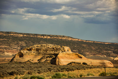 Rock formations on landscape against sky
