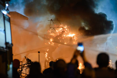 Crowd against fire at night