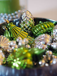 Close-up of shiny christmas ornaments in bowl
