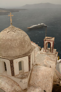 High angle view of lighthouse by sea against sky