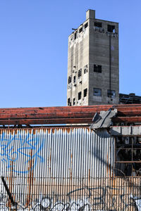 Low angle view of building against clear blue sky