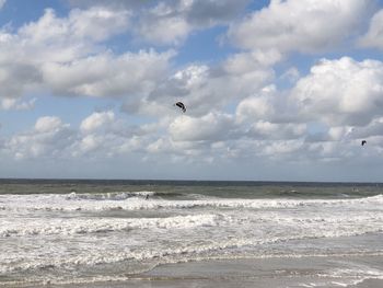 Scenic view of sea against sky with kiste surfer