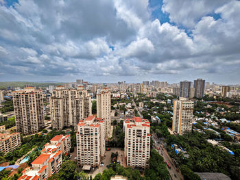 Cityscape against cloudy sky