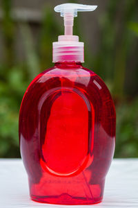 Close-up of water bottle on illuminated table