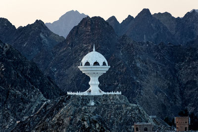 Church against sky with mountain range in background