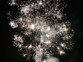 Low angle view of firework display at night