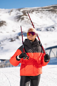 Full length of man skiing on snow covered field