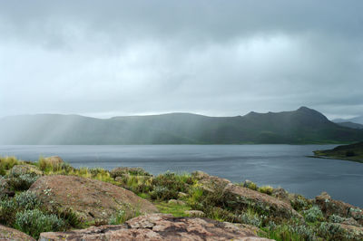 Scenic view of lake and mountains against sky