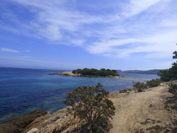 Scenic view of sea and island against sky