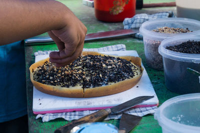 Close-up of person preparing food on table