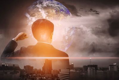 Digital composite image of businessman with cityscape and planet earth