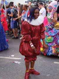 Portrait of young woman standing on street