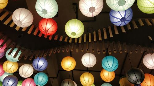 Low angle view of illuminated lanterns hanging on ceiling