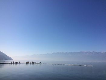 Scenic view of sea against clear blue sky