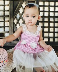 Portrait of cute girl sitting in traditional clothing