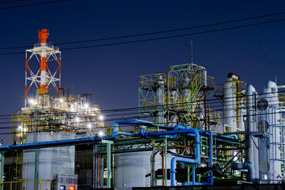 Factory building against sky at night