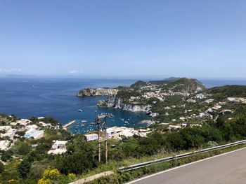 High angle view of city by sea against sky