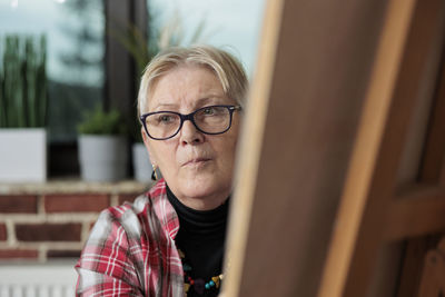 Senior woman looking away in drawing class