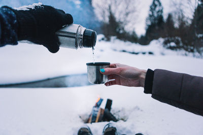 Close-up of hand on snow