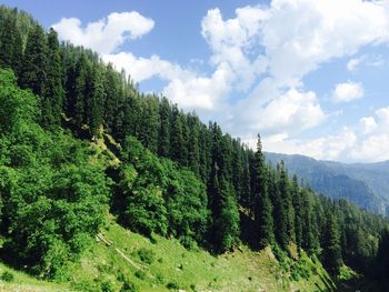 Scenic view of mountains against cloudy sky