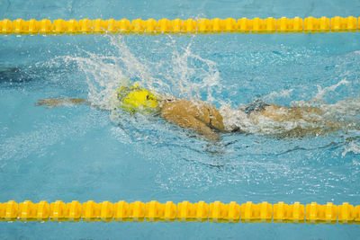 High angle view of woman swimming in pool