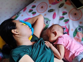 High angle view of woman breastfeeding baby