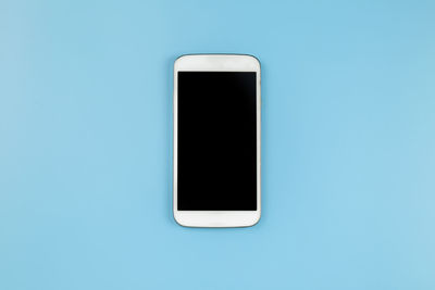 Close-up of smart phone against white background
