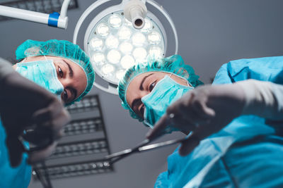 Midsection of doctor examining patient in hospital